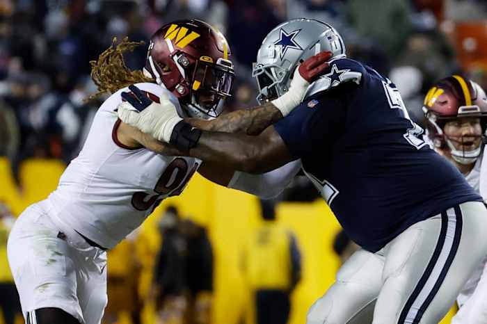 Defensive end Chase Young (left) goes up against a Dallas Cowboys offensive lineman (right).